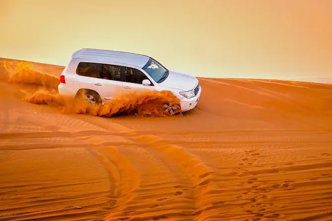 Luxury 4×4 Land Cruiser on Dubai desert dunes during safari 2025